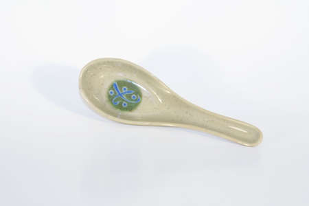 An asian soup spoon is shot against a white background for easy isolation.  Good for use on menus or other designs.の写真素材