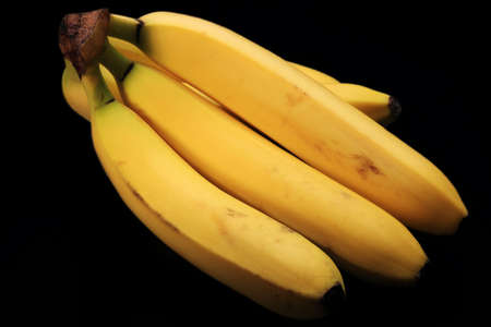 Bunch of Bananas Isolated on Black Backgroundの写真素材