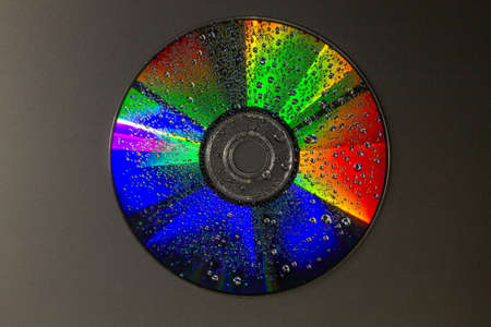 light and water droplets on a dvd disk to produce amazing colours - stock photoの写真素材