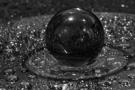 black and white  image of marble on water droplet dvd diskの写真素材