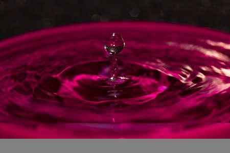 Pink water splash orb balanced on a water spike, quite an amazing photo really and i enjoyed getting these amazing photo'sの写真素材