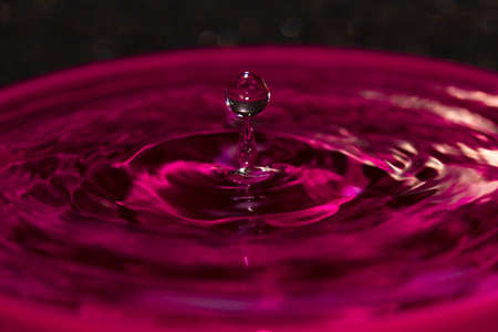 Pink water splash orb balanced on a water spike, quite an amazing photo really and i enjoyed getting these amazing photo'sの写真素材
