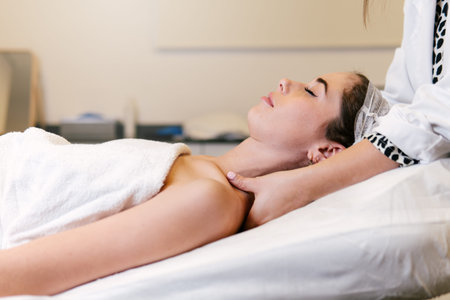 Woman getting a massage and relaxing treatment at a private beauty clinic.