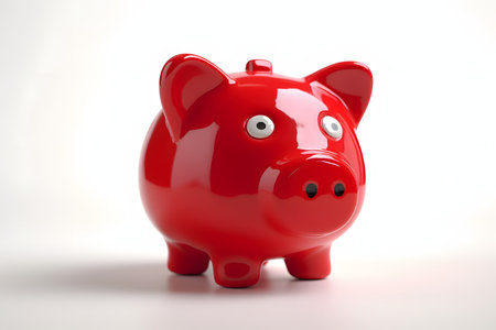 Red piggy bank on a white background. 3D illustration.の素材