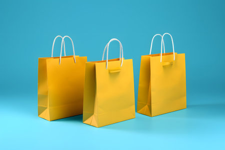 Three yellow shopping bags on blue background. 3d render illustration.の素材