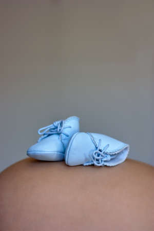 Baby Shoes on Pregnantの写真素材