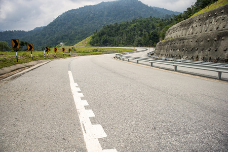 Close up asphalt curve road texture on hillの写真素材
