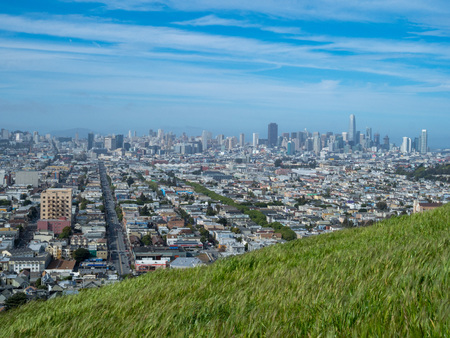 Grassy meadow overlooking San Francisco skyline on a cloudy dayのeditorial素材