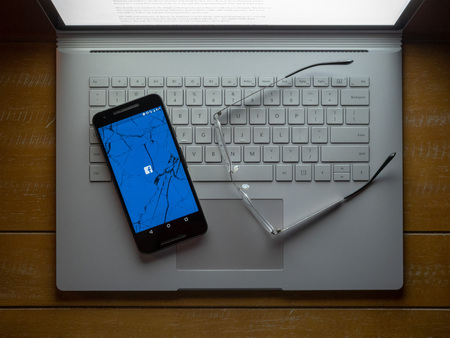 APRIL 8, 2018: Facebook has been in hot water for privacy troubles from the Cambridge Analytica scandal. This picture reflects the broken trust users have in the platform.のeditorial素材