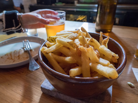 Crispy french fries eaten mid mealの写真素材