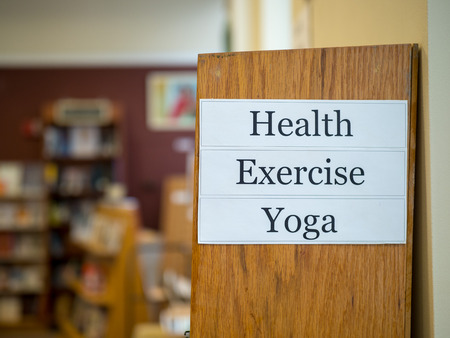 Health, Exercise, Yoga sign hanging at a book storeの写真素材
