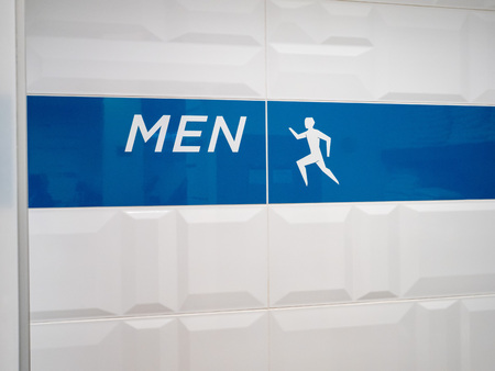 Men's locker room entrance sign in modern office settingの写真素材