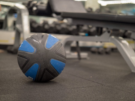 Unmarked medicine ball in modern gym with space to right