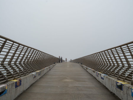 Passerbys on a pier on a fooy day in San Francisco