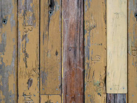 Different weathered wooden planks arranged along wall outdoorsの写真素材