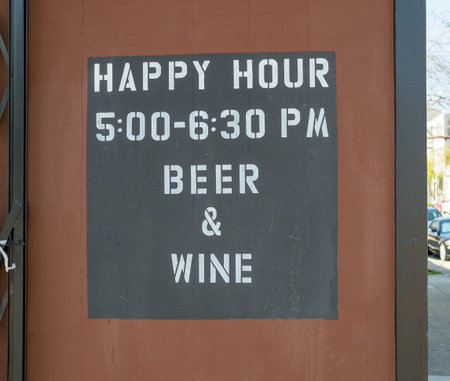 Happy hour, wine and beer, sign outdoors. 5:30 to 6:30 PMの写真素材