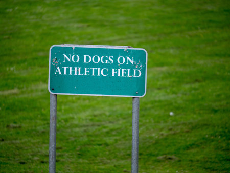 "No dogs on athletic field" sign erected in a parkの写真素材