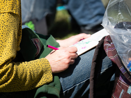 Woman writing in journal with a red pen