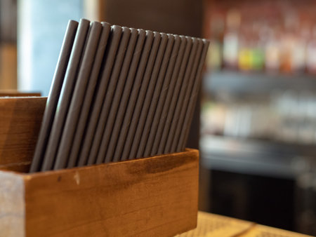 Container filled with paper straws at a bar ready to be used in drinksの写真素材