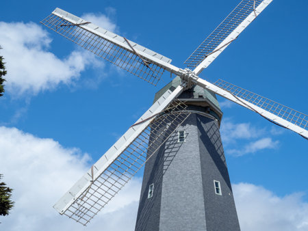A large sun glowed windmill rotating in the outdoors