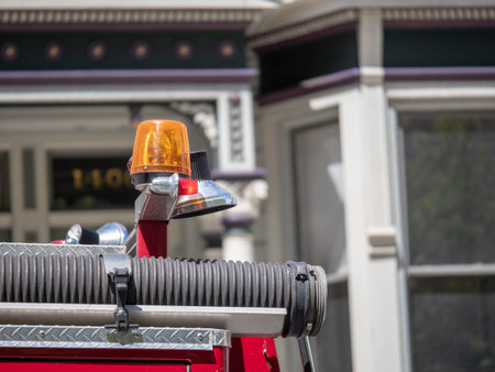Yellow siren on top of a fire truck running outdoors in the city