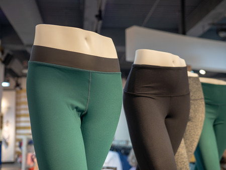 Plastic athletic mannequin lower bodies posing with yoga pants in a storeの写真素材