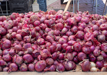 A mound of red onions and shallots for sale at a farmers marketの写真素材