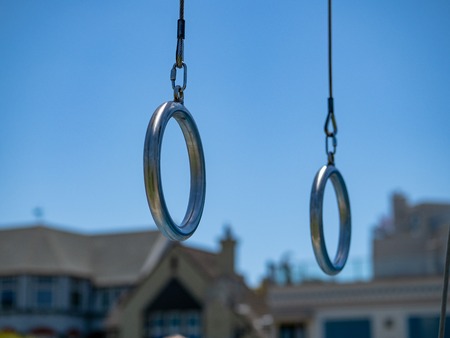 Steel gymnastic rings hanging at an outdoor gym in a residentialの写真素材