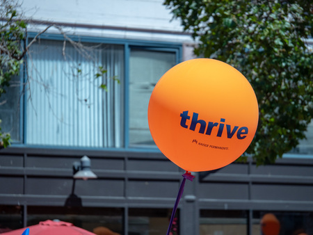 Orange Kaiser Permanente thrive balloon flying in an urban areaのeditorial素材