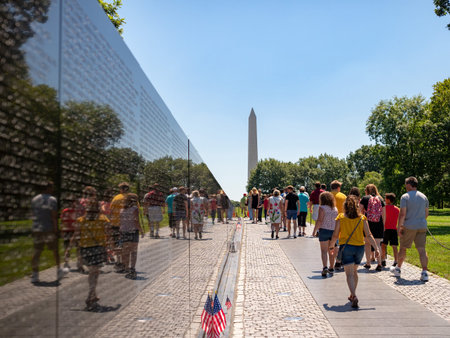 Vietnam Veterans Memorial with tourists and Washington Monument in backgroundのeditorial素材