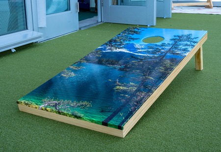 Cornhole platform with nature theme sitting on turfの写真素材