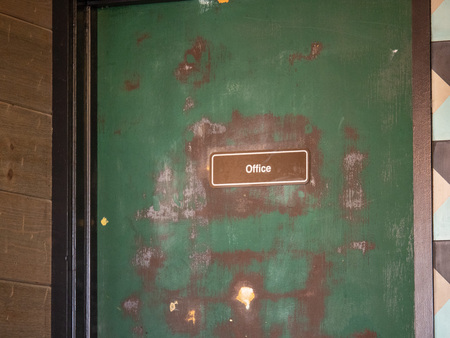 Green door office door card with paint stripping and rundownの写真素材