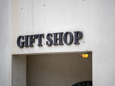 Gift shop entrance sign above entryway on concrete buildingの写真素材