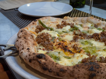 Sausage pizza with high crust, uncut and ready to serve