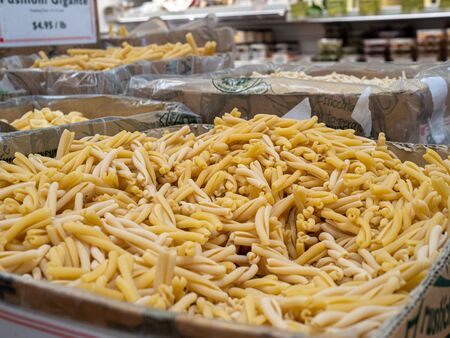 Mound of dried gemelli pasta in storage ready to cookの写真素材