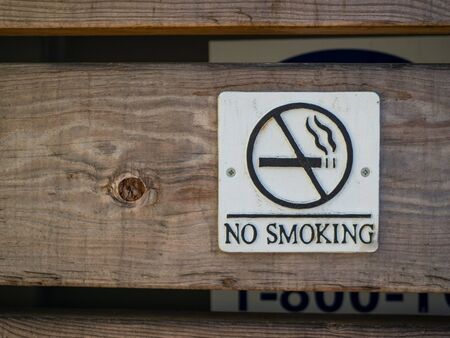 No smoking logo and warning posted on wooden board wallの写真素材
