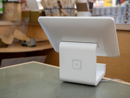Square register point of sale machine sitting on counter in storeのeditorial素材