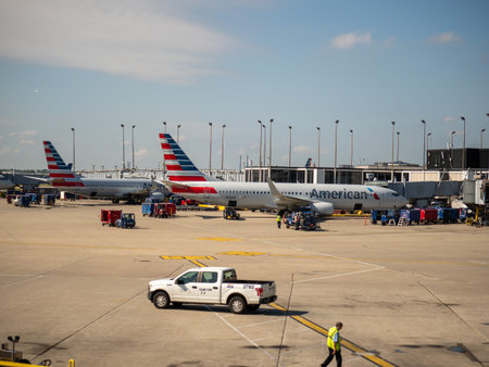 American Airlines planes sitting at airport terminal refuelingのeditorial素材