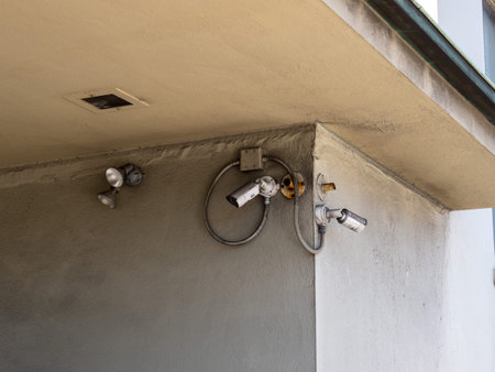 Various security cameras, lights and motion detectors outside building