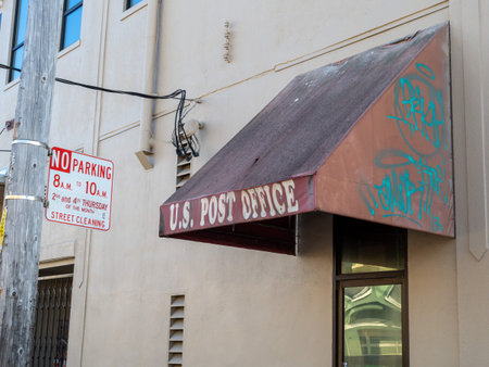 Beat up US post office awning covered in graffiti and some filth