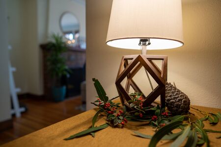 Simple home lamp with pinecone and twigs and berries as decorationsの写真素材
