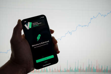 San Francisco, California February 09, 2020: Robinhood app on phone with white financial stock chart with price rising upward positive in backgroundのeditorial素材