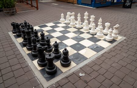Human sized chest board in public square with white and black set of piecesの写真素材