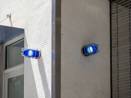 Two blue caution safety lights on corner of a building outsideの写真素材