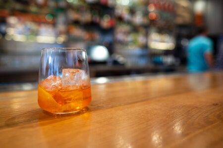 Half full empty spritz cocktail drink on counter in a barの写真素材