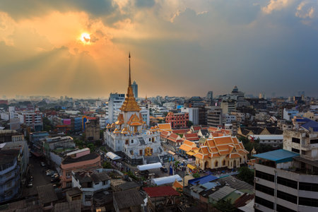 Aerial view cityscape & Sunbeam Wat Traimit (Thai Temple) Inside of there have Golden Buddha that...