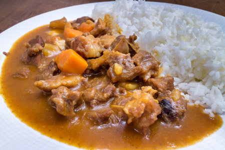 Healthy japanese style curry beef with rice in a white dish on wood table background for ready to serve.の写真素材