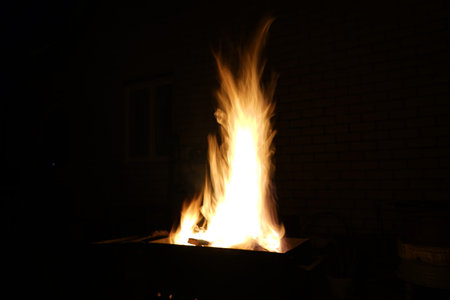 A large tongue of flame in the grillの写真素材