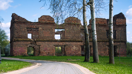 A dilapidated red brick building in the distance