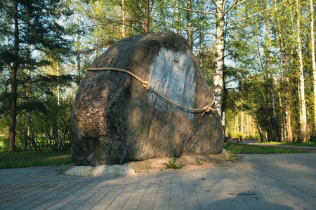 A huge, flat stone, tied with a rope. High quality photoの写真素材